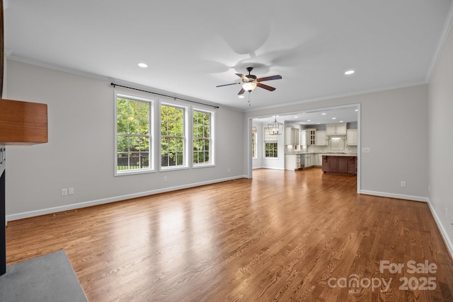 3206 Lakehurst Xing, Matthews, NC 28104 - unfurnished living room featuring a ceiling fan, ornamental molding, baseboards, light wood-style floors, and recessed lighting