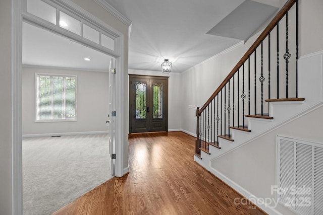3206 Lakehurst Xing, Matthews, NC 28104 - foyer entrance with stairway, crown molding, wood finished floors, and baseboards