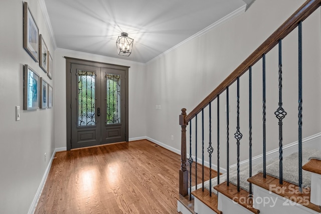 3206 Lakehurst Xing, Matthews, NC 28104 - entrance foyer featuring wood finished floors, stairway, ornamental molding, baseboards, and a chandelier