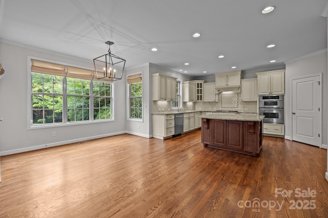 3206 Lakehurst Xing, Matthews, NC 28104 - kitchen with cream cabinetry, stainless steel appliances, ornamental molding, healthy amount of natural light, and recessed lighting