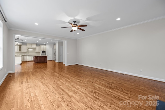 3206 Lakehurst Xing, Matthews, NC 28104 - unfurnished living room featuring a ceiling fan, wood finished floors, baseboards, recessed lighting, and crown molding