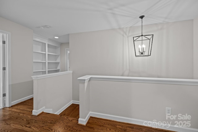 3206 Lakehurst Xing, Matthews, NC 28104 - hall with wood finished floors, a chandelier, baseboards, and an upstairs landing