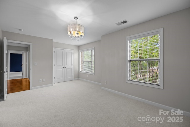 3206 Lakehurst Xing, Matthews, NC 28104 - unfurnished bedroom with baseboards, a chandelier, carpet, and a closet