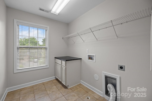 3206 Lakehurst Xing, Matthews, NC 28104 - laundry area with hookup for an electric dryer, washer hookup, baseboards, light tile patterned flooring, and hookup for a gas dryer