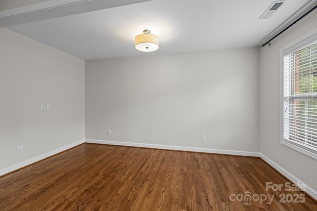 3206 Lakehurst Xing, Matthews, NC 28104 - spare room featuring dark wood-style flooring and baseboards