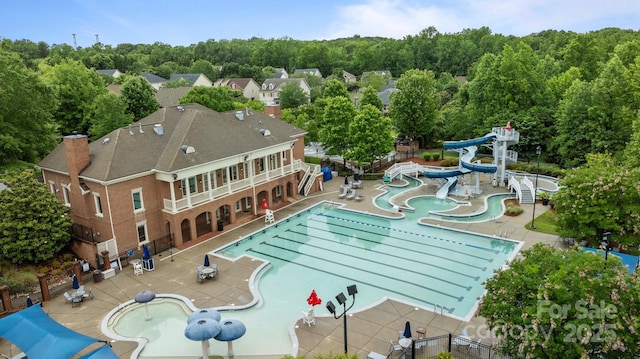 3206 Lakehurst Xing, Matthews, NC 28104 - community pool featuring a water slide and a patio area