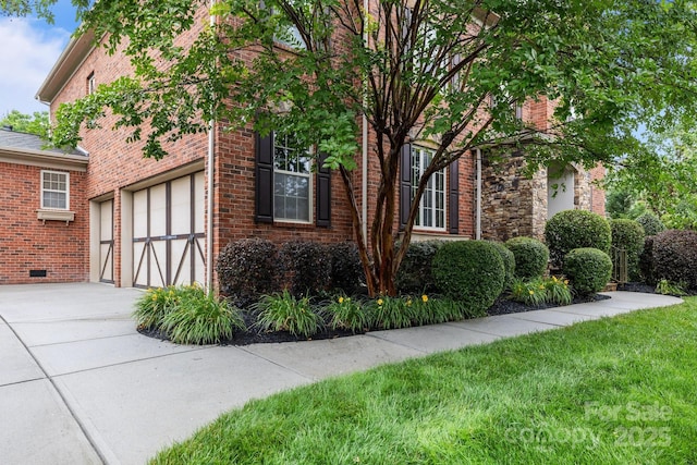 3206 Lakehurst Xing, Matthews, NC 28104 - view of property exterior featuring concrete driveway, brick siding, a yard, and an attached garage