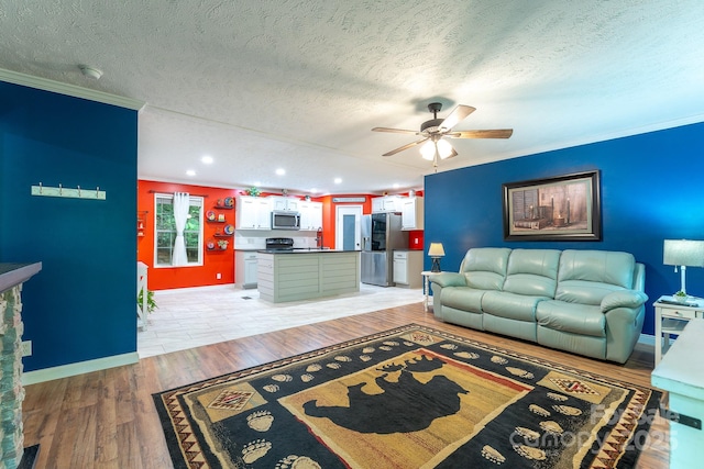 225 Opal Dr, Whittier, NC 28789 - living area with ornamental molding, a ceiling fan, a textured ceiling, recessed lighting, and light wood-style flooring
