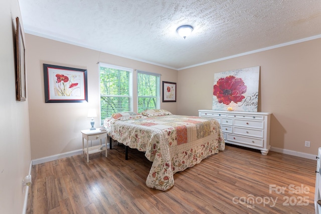 225 Opal Dr, Whittier, NC 28789 - bedroom with wood finished floors, a textured ceiling, baseboards, and crown molding