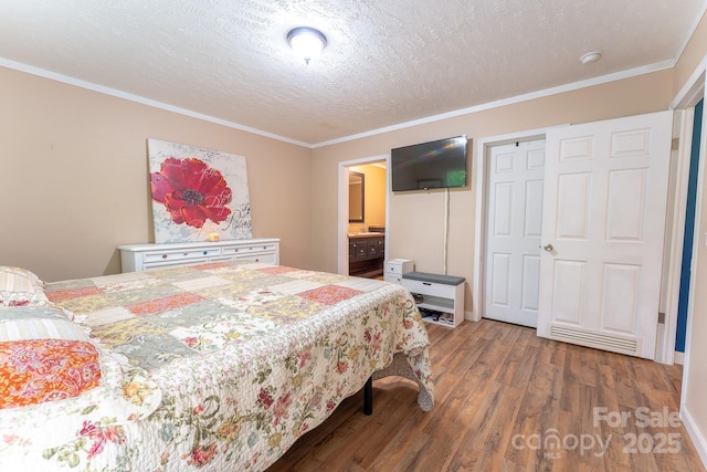 225 Opal Dr, Whittier, NC 28789 - bedroom with wood finished floors, ornamental molding, a textured ceiling, and connected bathroom