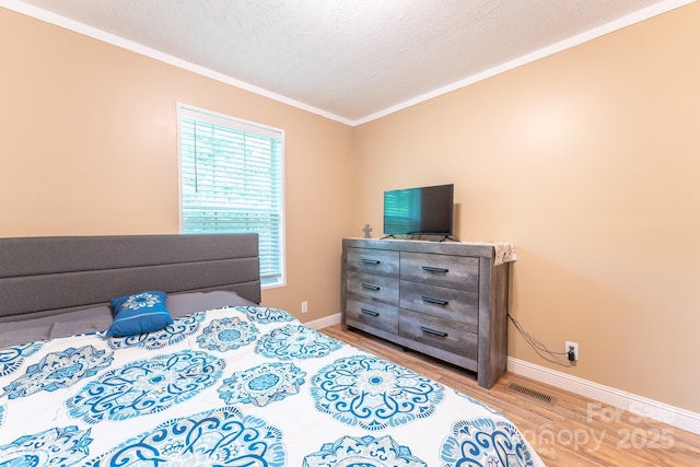 225 Opal Dr, Whittier, NC 28789 - bedroom featuring light wood finished floors, ornamental molding, baseboards, and a textured ceiling