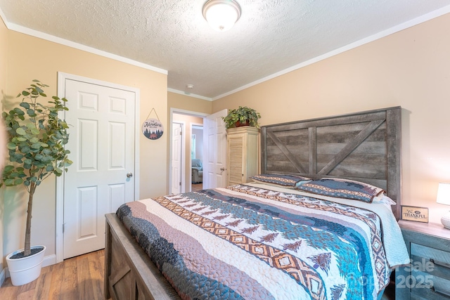 225 Opal Dr, Whittier, NC 28789 - bedroom with wood finished floors, a textured ceiling, and ornamental molding