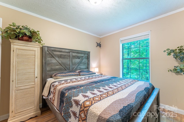 225 Opal Dr, Whittier, NC 28789 - bedroom with light wood finished floors, baseboards, ornamental molding, and a textured ceiling