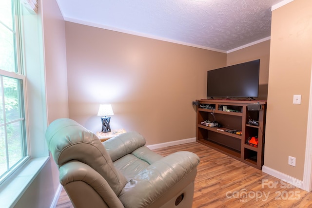 225 Opal Dr, Whittier, NC 28789 - living room featuring wood finished floors, a textured ceiling, baseboards, and crown molding