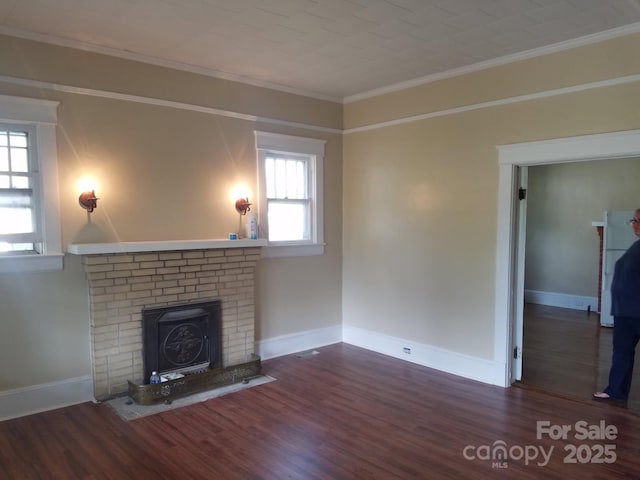 607 Lee Ave, Wadesboro, NC 28170 - unfurnished living room featuring a fireplace, ornamental molding, wood finished floors, and baseboards