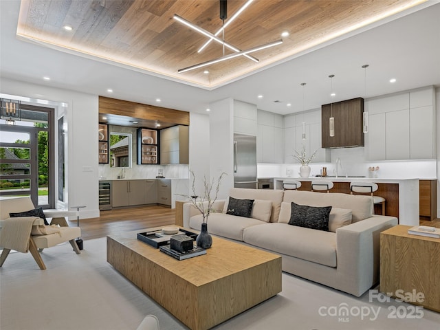 63 Running Creek Trl, Arden, NC 28704 - living area featuring beverage cooler, recessed lighting, a chandelier, light wood-style flooring, and bar
