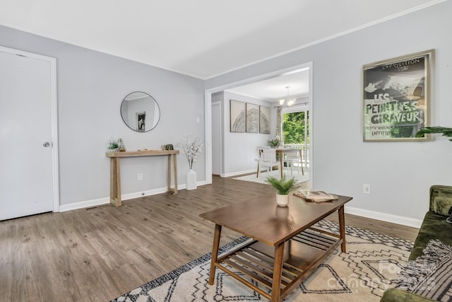 35 Avondale Rd, Asheville, NC 28803 - living room with wood finished floors, baseboards, ornamental molding, and a chandelier