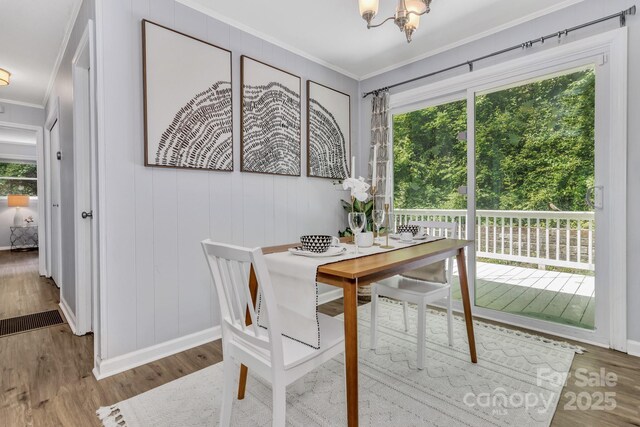 35 Avondale Rd, Asheville, NC 28803 - dining room with ornamental molding, a chandelier, wood finished floors, and baseboards