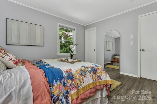 35 Avondale Rd, Asheville, NC 28803 - bedroom featuring wood finished floors, ornamental molding, baseboards, and arched walkways