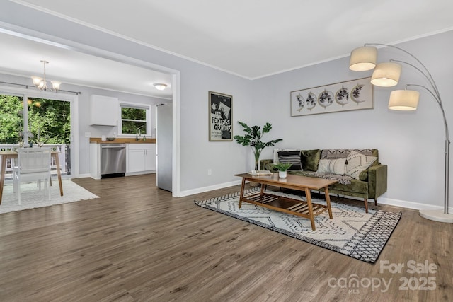 35 Avondale Rd, Asheville, NC 28803 - living area with a chandelier, dark wood-type flooring, crown molding, and baseboards