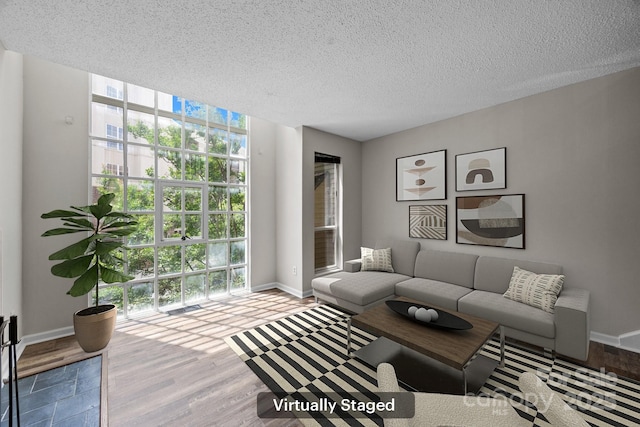 415 W 7th St Unit H, Charlotte, NC 28202 - living room with baseboards, wood finished floors, and a textured ceiling