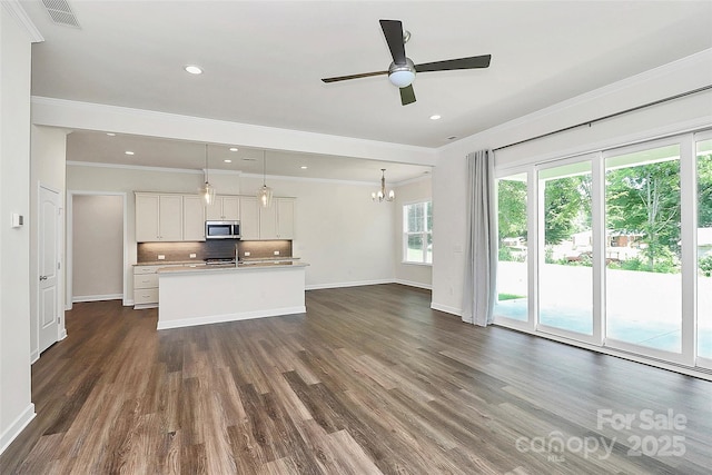 163 Crenshaw Pl NW, Concord, NC 28027 - kitchen with stainless steel microwave, crown molding, a chandelier, dark wood-style floors, and baseboards