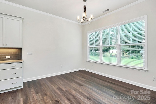 163 Crenshaw Pl NW, Concord, NC 28027 - unfurnished dining area featuring a chandelier, dark wood-style floors, baseboards, and crown molding