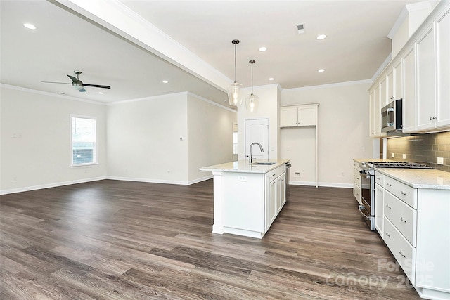 163 Crenshaw Pl NW, Concord, NC 28027 - kitchen with appliances with stainless steel finishes, a sink, baseboards, a ceiling fan, and tasteful backsplash
