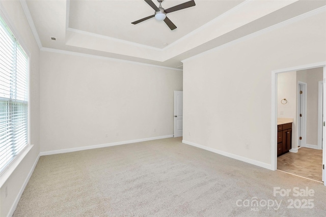 163 Crenshaw Pl NW, Concord, NC 28027 - spare room with light carpet, a raised ceiling, a ceiling fan, ornamental molding, and baseboards
