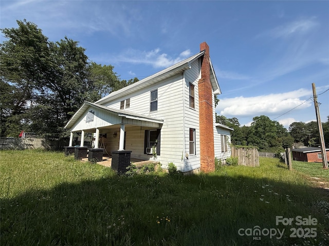 1445 33rd St SW, Hickory, NC 28602 - back of house with a chimney, fence, and covered porch