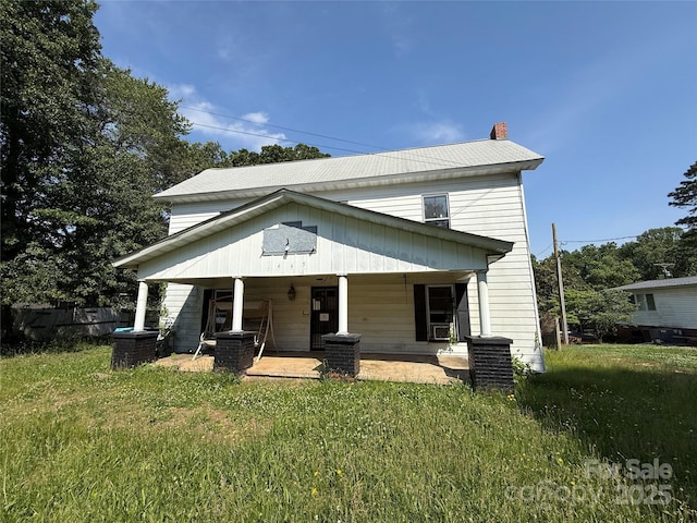 1445 33rd St SW, Hickory, NC 28602 - view of front of property with a porch, a chimney, and a front yard