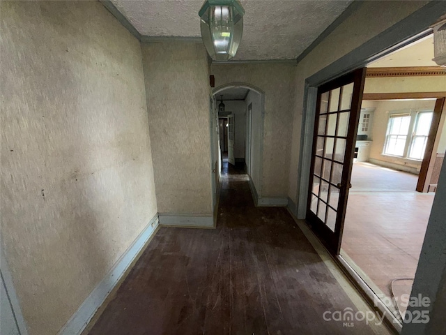 1445 33rd St SW, Hickory, NC 28602 - corridor featuring arched walkways, baseboards, french doors, a textured ceiling, and wood finished floors