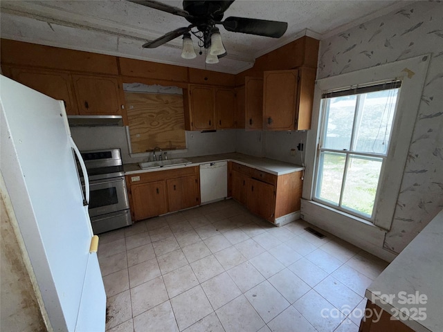 1445 33rd St SW, Hickory, NC 28602 - kitchen with white appliances, wallpapered walls, light countertops, under cabinet range hood, and a sink