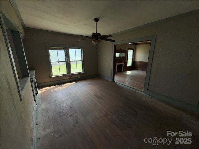 1445 33rd St SW, Hickory, NC 28602 - unfurnished living room featuring a ceiling fan, wood finished floors, and a fireplace