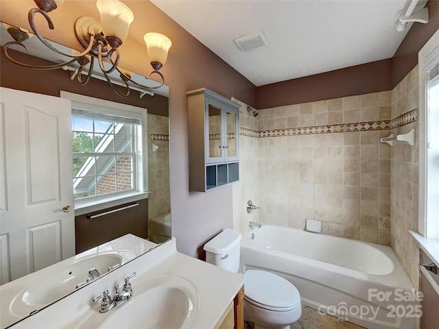 bathroom with vanity, toilet,  shower combination, and a chandelier