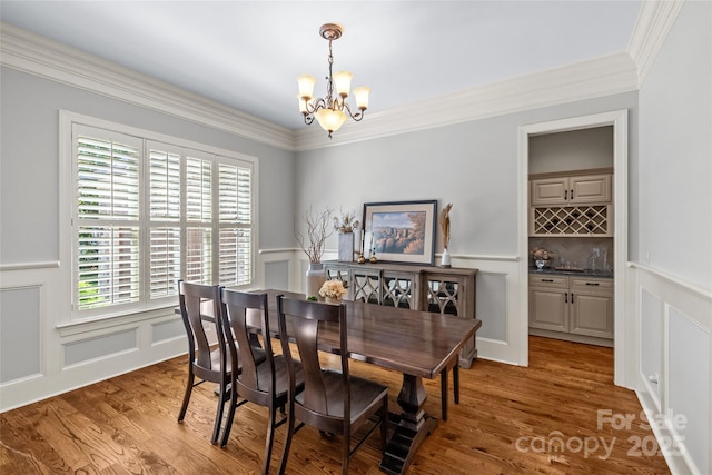 6211 Cruden Bay Way, Charlotte, NC 28277 - dining room featuring a decorative wall, a chandelier, plenty of natural light, a wainscoted wall, and crown molding