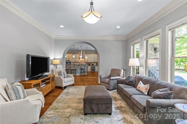 6211 Cruden Bay Way, Charlotte, NC 28277 - living area with arched walkways, wood finished floors, ornamental molding, and recessed lighting
