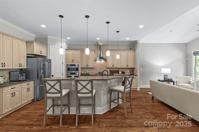 6211 Cruden Bay Way, Charlotte, NC 28277 - kitchen featuring cream cabinetry, appliances with stainless steel finishes, wall chimney exhaust hood, a breakfast bar, and decorative backsplash