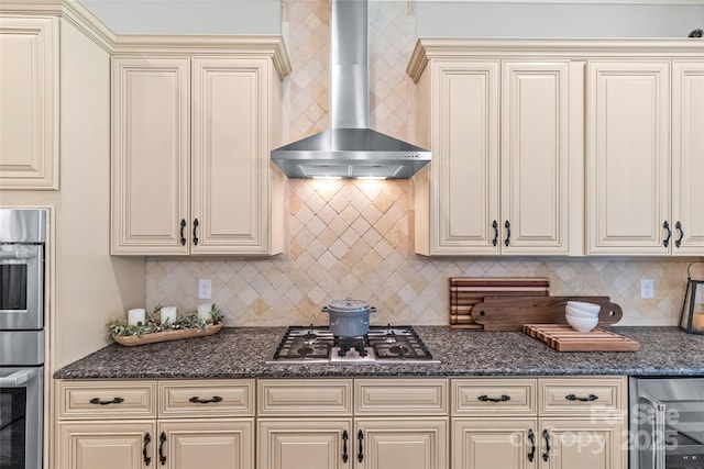 6211 Cruden Bay Way, Charlotte, NC 28277 - kitchen featuring wall chimney exhaust hood, cream cabinets, appliances with stainless steel finishes, beverage cooler, and decorative backsplash