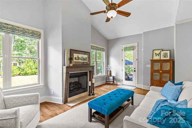 6211 Cruden Bay Way, Charlotte, NC 28277 - living area with ceiling fan, light wood-style floors, a fireplace with flush hearth, and high vaulted ceiling