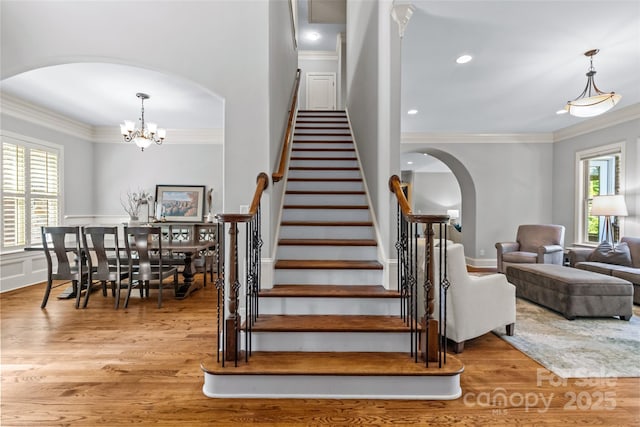 6211 Cruden Bay Way, Charlotte, NC 28277 - stairs with arched walkways, wood finished floors, ornamental molding, plenty of natural light, and recessed lighting