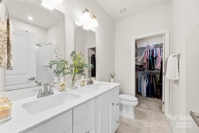 3748 Ellington St, Charlotte, NC 28211 - bathroom featuring a shower stall, tile patterned flooring, and a walk in closet