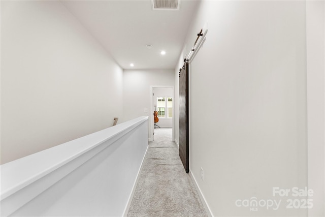 3748 Ellington St, Charlotte, NC 28211 - hall featuring a barn door, light carpet, recessed lighting, and baseboards
