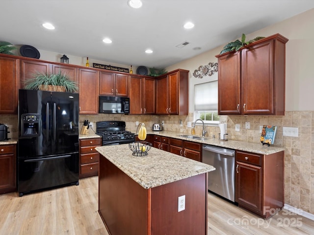 1051 Streamlet Way, Monroe, NC 28110 - kitchen with black appliances, a sink, light wood finished floors, light stone countertops, and recessed lighting