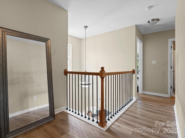 1051 Streamlet Way, Monroe, NC 28110 - corridor with wood finished floors, baseboards, and an upstairs landing