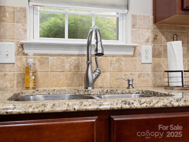1051 Streamlet Way, Monroe, NC 28110 - kitchen view of a sink, backsplash, and light stone countertops