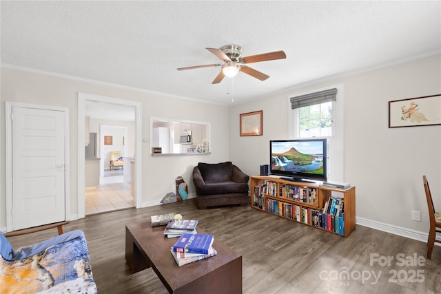485 Lincoln St, Cramerton, NC 28032 - living room featuring wood finished floors, ceiling fan, ornamental molding, baseboards, and a textured ceiling