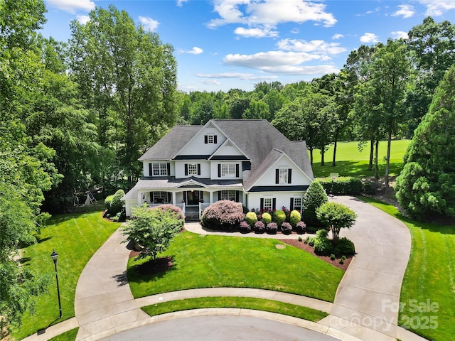 19946 River Falls Dr, Davidson, NC 28036 - view of front of home featuring curved driveway, a porch, and a front yard
