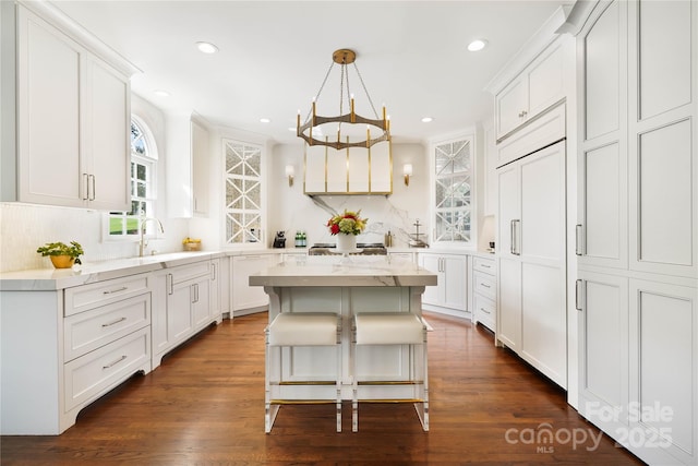 19946 River Falls Dr, Davidson, NC 28036 - kitchen with a sink, white cabinets, recessed lighting, a center island, and dark wood-style flooring