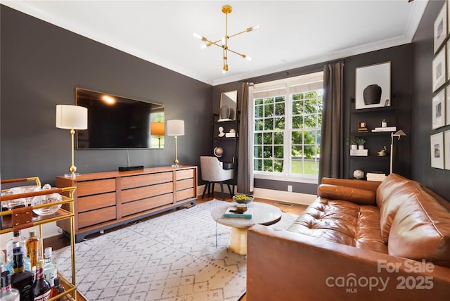 19946 River Falls Dr, Davidson, NC 28036 - living room featuring crown molding, a chandelier, baseboards, and wood finished floors